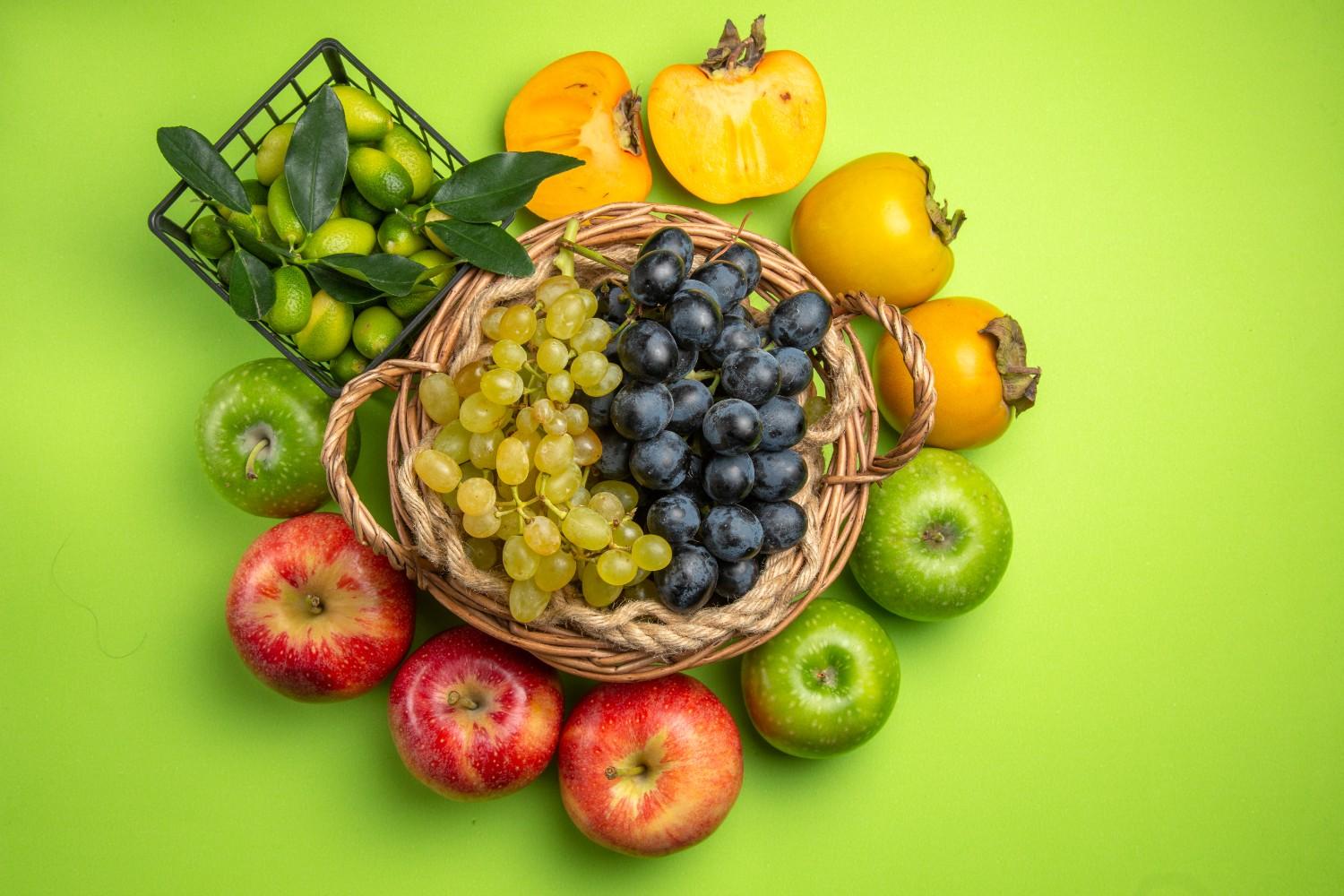 top-view-fruits-basket-bunches-grapes-persimmons-apples-basket-citrus-fruits
