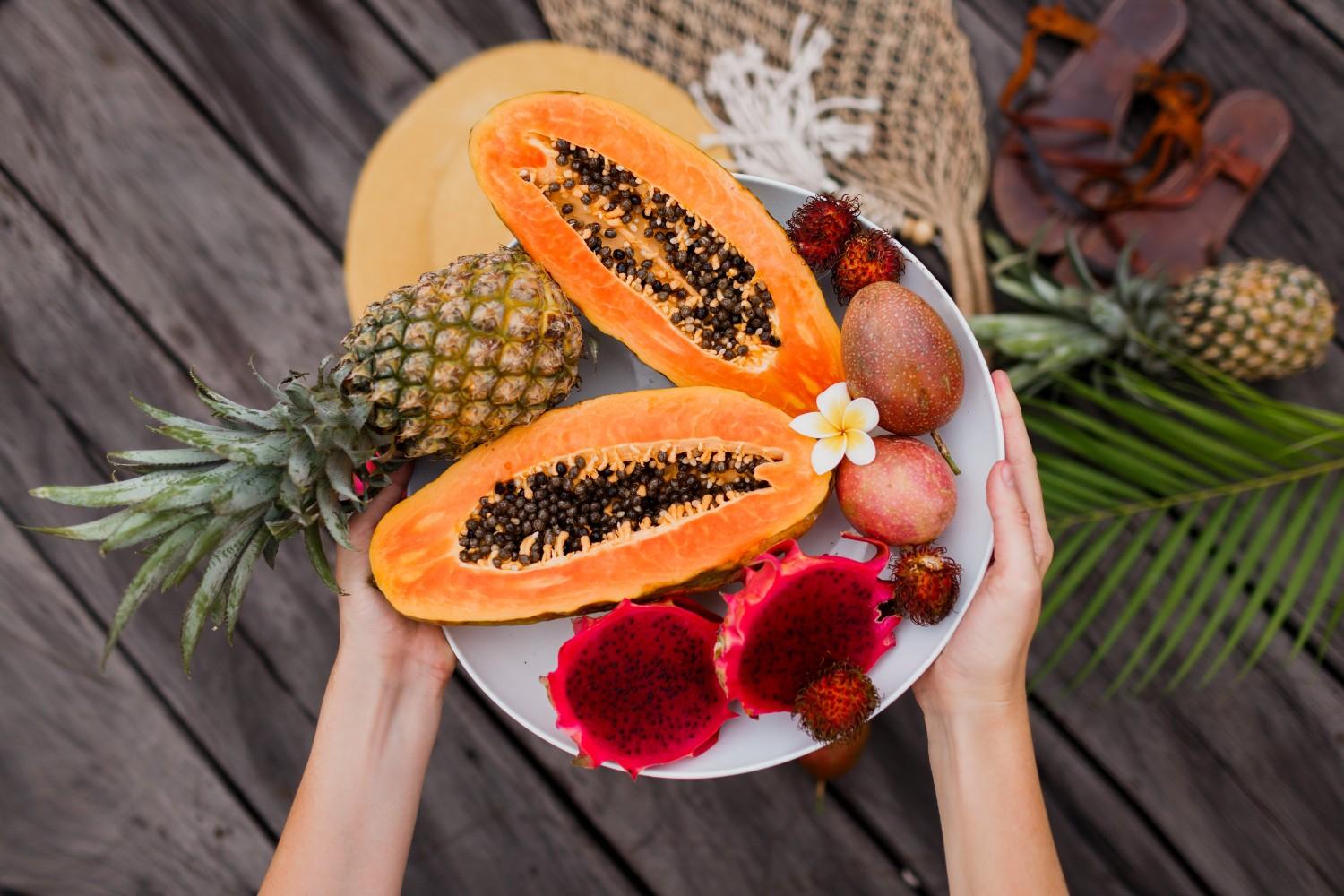 woman-s-hands-with-big-plate-fresh-exotic-fruits